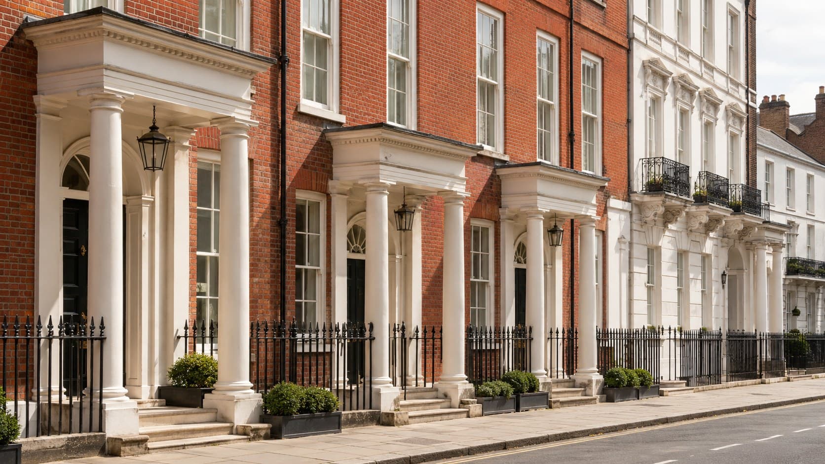 An elegant Georgian London terrace of red brick and pale stucco with porticoes